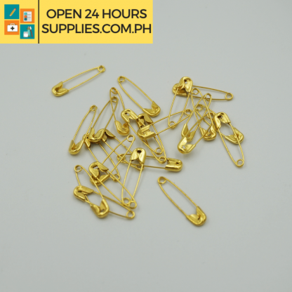 A close up photo of safety pins gold